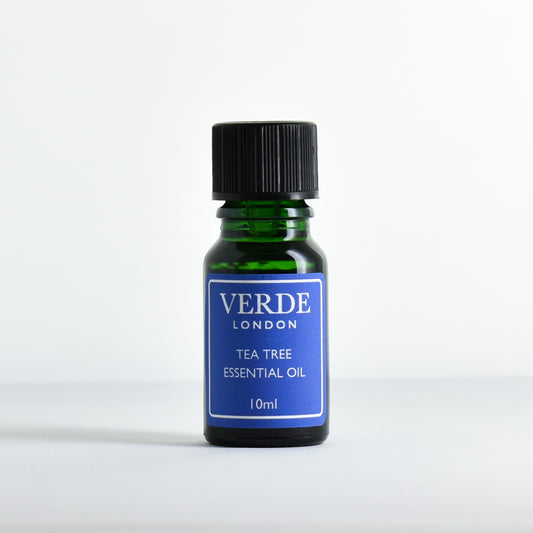 Green glass dropper bottle containing 'Tea Tree Essential Oil' by Verde London on a white background.