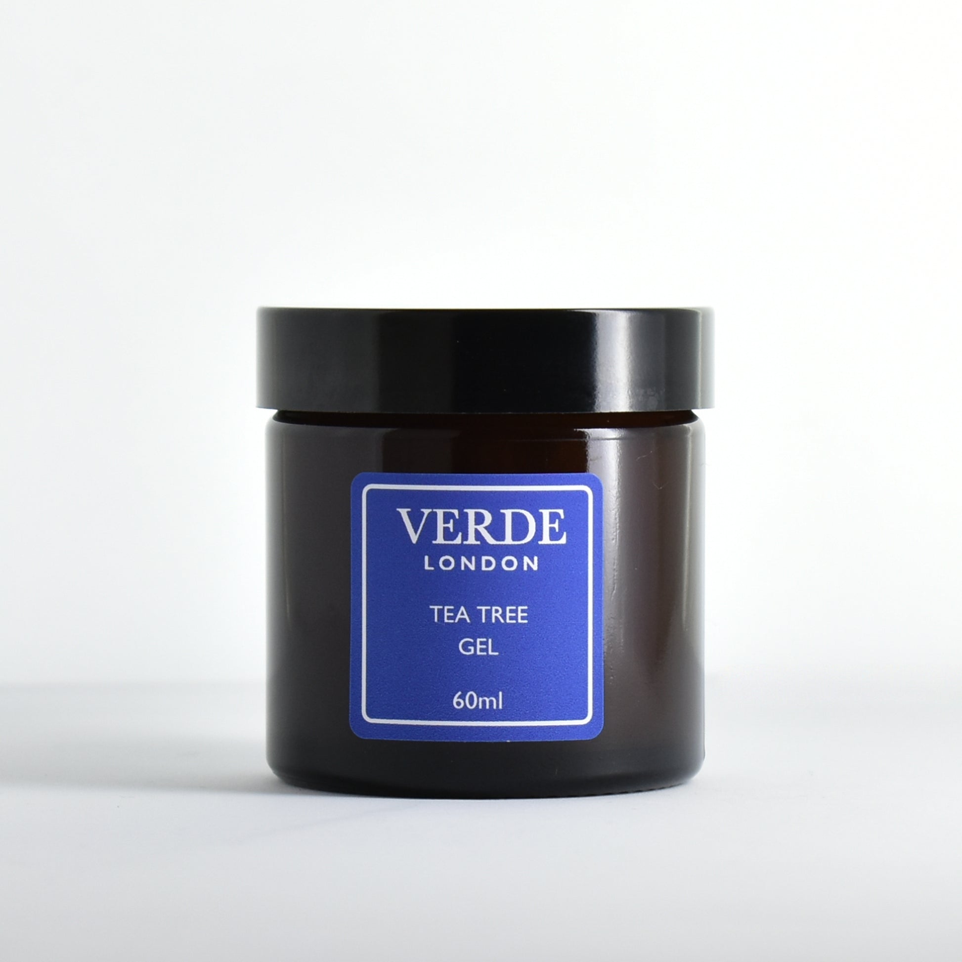 Amber glass jar of Verde London Tea Tree Gel with a blue label on a white background