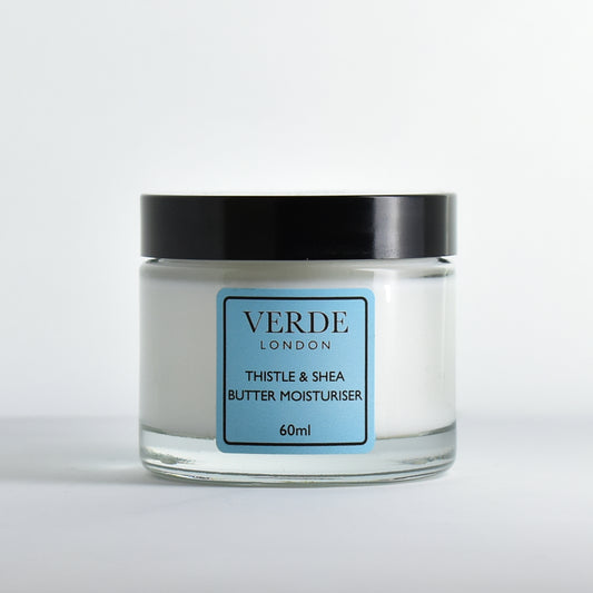 Glass jar of Verde London Thistle and Shea Butter Moisturiser with a blue label on a white background