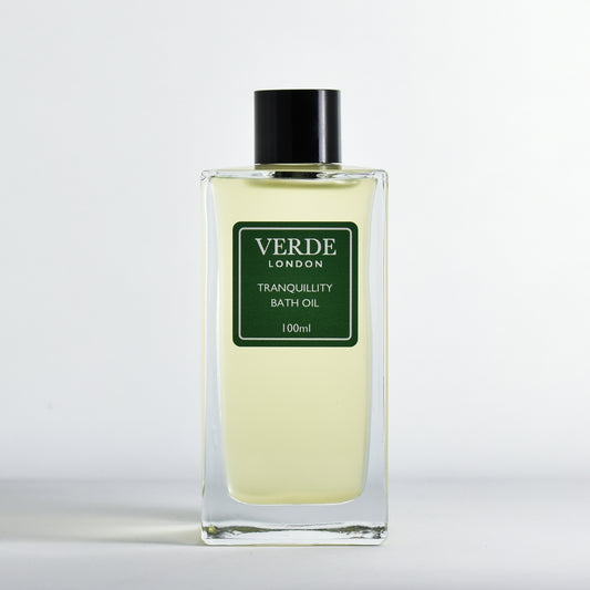 Bottle of Tranquillity Bath Oil by Verde London in a rectangular clear glass bottle with a green label on a white background
