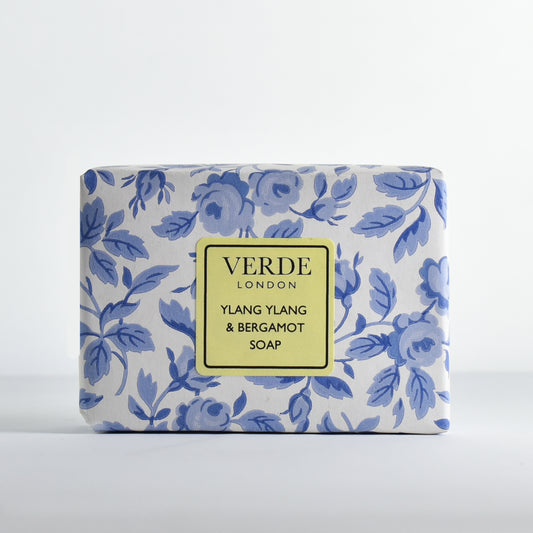 Bar of Ylang Ylang and Bergamot soap by Verde London wrapped in white and blue floral paper with a pale yellow label on a white background
